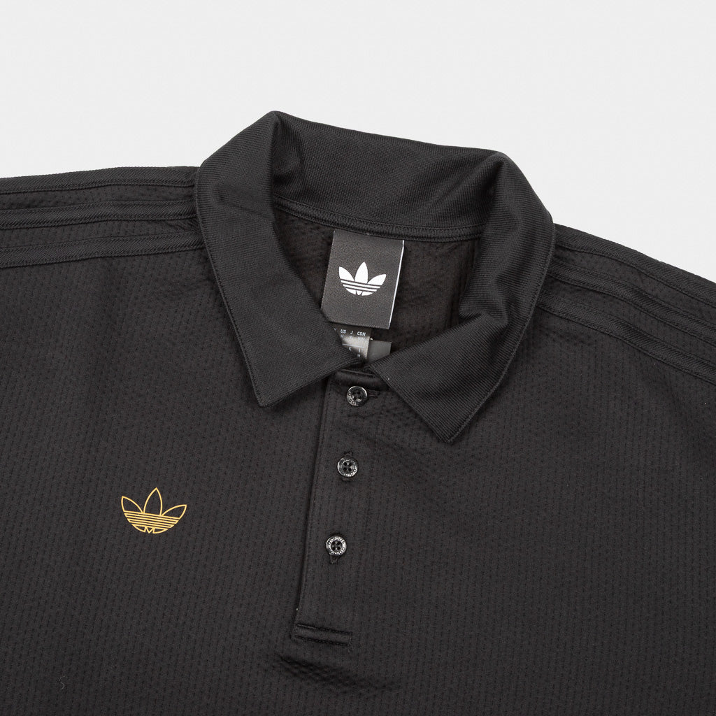 Collar And Branding Details Of Adidas Skateboarding Tyhswan Jones Rugby Shirt In Black